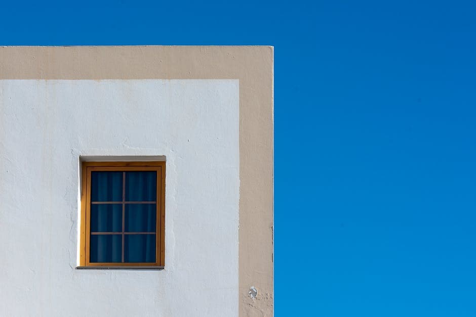 Minimalist Window on White Building Against Blue Sky