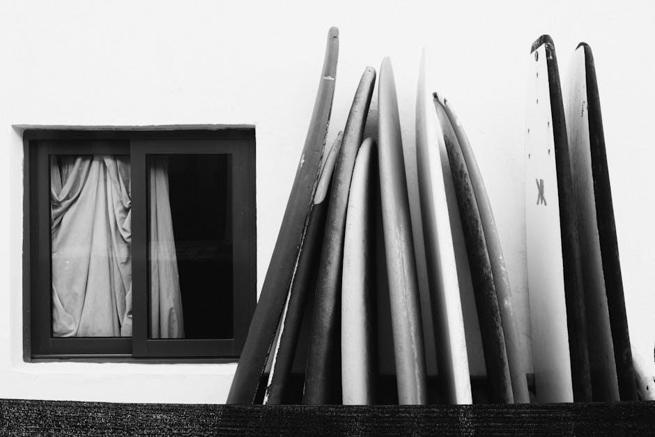 Black and White Surfboards Leaning Against Wall