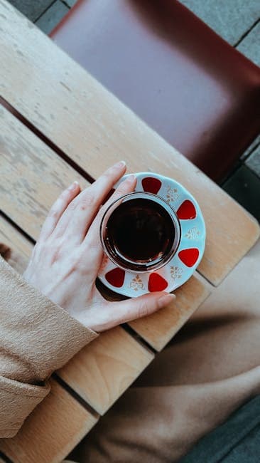 Overhead View of Person Holding Coffee Cup Outdoors