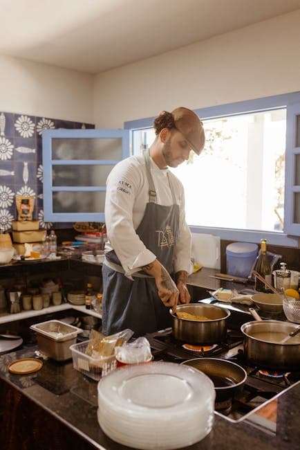 Chef in Modern Kitchen Cooking a Dish