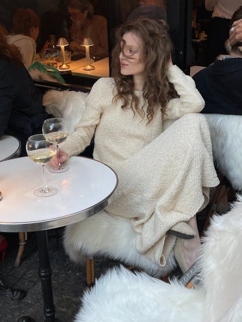 Elegant Woman Relaxing with Wine at Chic Café