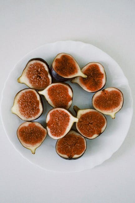 Fresh Halved Figs on White Plate, Flat Lay