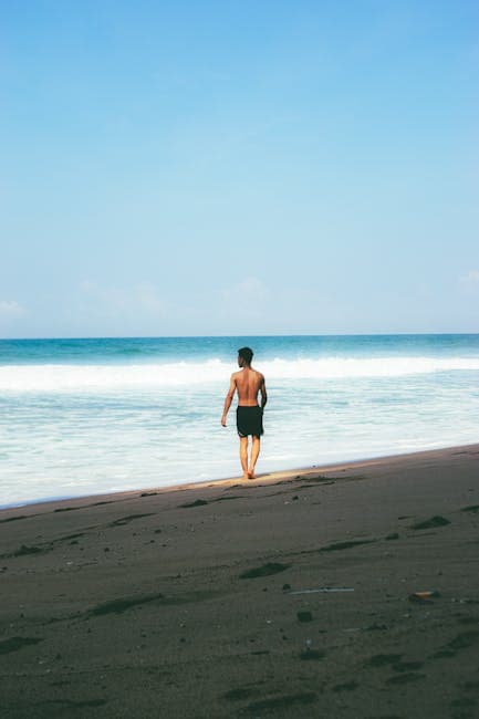 Man Walking on Parangtritis Beach in Yogyakarta